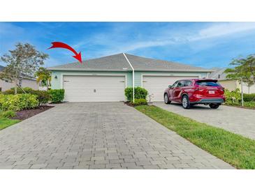 Charming villa with a gray brick driveway, a two-car garage, and beautiful landscaping at 17732 Wayside Bnd, Punta Gorda, FL 33982