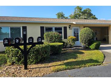 Charming villa exterior with manicured landscaping, multiple mailboxes, and well-maintained facade at 390 301 W Blvd # 5B, Bradenton, FL 34205