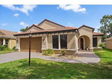 Charming single-story home with a tile roof, lush landscaping, and a welcoming front entrance at 5624 Aaron Ct, Sarasota, FL 34232