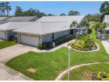 Charming single-story home with well-manicured lawn and attached two-car garage at 7724 Palm Aire Ln, Sarasota, FL 34243