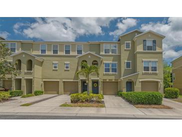 Charming townhouse exterior showcasing well-maintained landscaping and inviting curb appeal at 9008 White Sage Loop # 3605, Lakewood Ranch, FL 34202