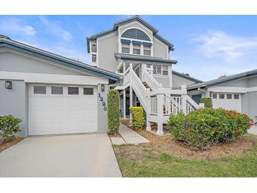 Charming two-story townhouse with well-maintained landscaping and a private one-car garage at 1223 Siesta Bayside Dr # 1223, Sarasota, FL 34242