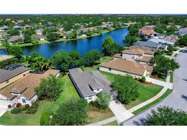 Beautiful waterfront home with lush landscaping and stunning lake views in a desirable community at 14230 Cattle Egret Pl, Lakewood Ranch, FL 34202
