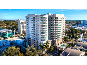Stunning exterior view of a modern high-rise condominium with balconies and a swimming pool at 1771 Ringling Blvd # 1104, Sarasota, FL 34236