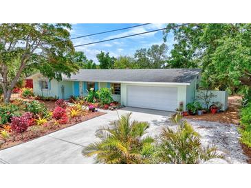 Well landscaped single Gathering home with a two car garage and baby blue shutters on this charming home at 3036 Rose St, Sarasota, FL 34239