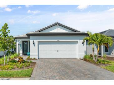 Charming single-story home featuring a spacious two-car garage and a beautifully landscaped front yard at 6248 Fish Eagle Ct, Nokomis, FL 34275