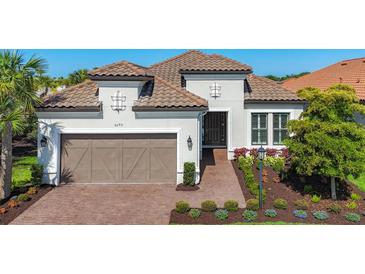 Charming single-Gathering home with a tile roof, attached garage, and beautifully landscaped front yard at 6290 Mesa Gln, Bradenton, FL 34203