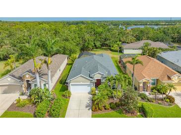 Beautiful single-story home featuring a well-manicured lawn and tropical landscaping at 8019 Indigo Ridge Ter, Bradenton, FL 34201