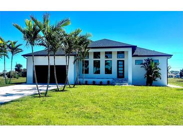 Beautiful single-Gathering home with a modern design, lush lawn, and elegant black trim at 217 Rotonda S Blvd, Rotonda West, FL 33947