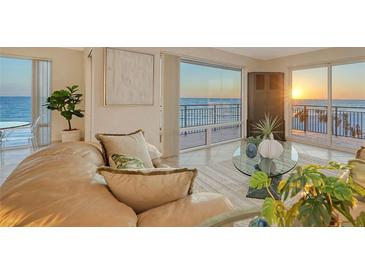 Living room with ocean view at sunset, offering a relaxing ambiance enhanced by natural light and modern decor at 2525 Gulf Of Mexico Dr # 3F, Longboat Key, FL 34228