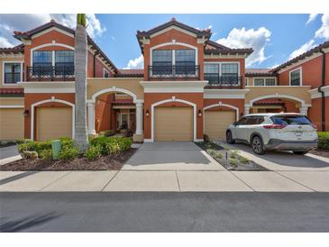 Charming townhome featuring a private garage, balcony, and well-manicured landscaping at 288 Crew Ct, Sarasota, FL 34243