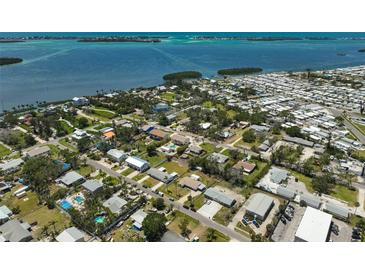 Stunning aerial view showcases a waterfront community with homes near the coast and beautiful blue ocean at 4420 101St W St, Bradenton, FL 34210