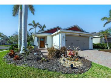 Charming single-story home with palm trees, garden, brick driveway, and well-maintained landscaping at 4838 San Ortebello Dr, Bradenton, FL 34208