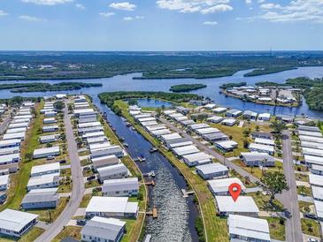 Waterfront community featuring boat canals, residences, and the Gulf of Mexico in the background at 649 Fairmount Dr, North Port, FL 34287