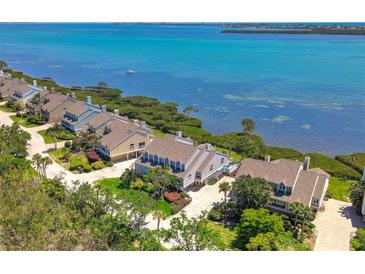 Waterfront homes with lush landscaping and stunning views of the bay at 78 Tidy Island Blvd, Bradenton, FL 34210