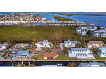 Beautiful waterfront home offering stunning views of the bay, with lush landscaping and ample boating opportunities at 780 Jungle Queen Way, Longboat Key, FL 34228