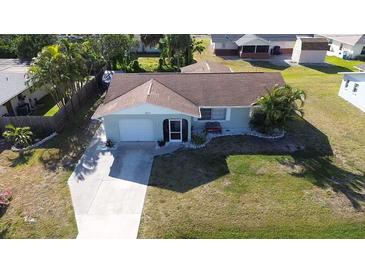 Aerial shot showcasing the home's layout, driveway, lawn, and surroundings at 807 Mohawk Rd, Venice, FL 34293
