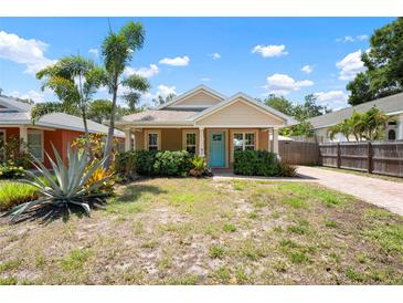 Charming single-story home with a bright blue door, well-kept landscaping, and a brick driveway at 1052 32Nd St, Sarasota, FL 34234