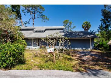Charming home with a welcoming front yard and a convenient attached two-car garage at 2511 Lords Ln, Sarasota, FL 34231