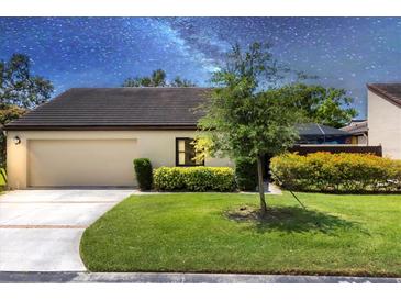Charming one-story home with lush green lawn and mature landscaping enhancing its curb appeal at 3698 Glen Oaks Manor Dr, Sarasota, FL 34232
