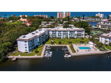 Waterfront condos boast a pool, boat docks, and verdant grounds with ocean views at 565 Sutton Place, Longboat Key, FL 34228