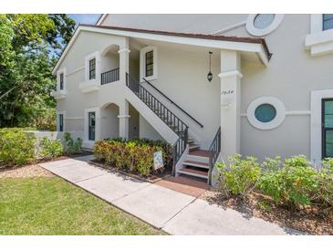 Charming two-story condo with well-maintained landscaping and inviting entryway with stairs and portico at 7639 Fairway Woods Dr # 605, Sarasota, FL 34238