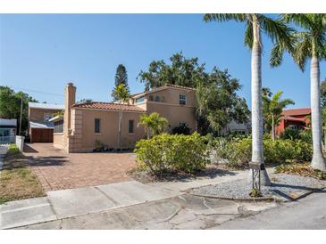 Charming Mediterranean home featuring a brick driveway, lush landscaping, and a classic tile roof at 344 N Lantana N Ave, Sarasota, FL 34243
