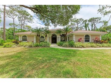 Beautiful one-story home with mature landscaping and tile roof at 5533 Ashley Pkwy, Sarasota, FL 34241