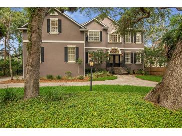 Beautiful home featuring a manicured front lawn, traditional design, and a welcoming entrance at 5716 Bayshore Blvd, Tampa, FL 33611