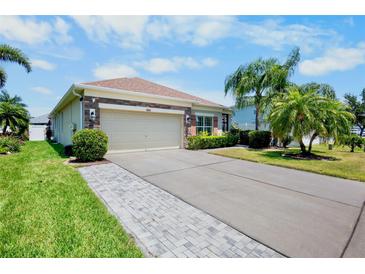 Charming home features a two-car garage, beautiful landscaping, and a well-manicured lawn at 9052 41St E St, Parrish, FL 34219