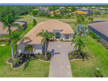 Beautiful single-story home featuring tile roof, lush landscaping and a paver driveway with compass design at 12811 Penguin Dr, Bradenton, FL 34212