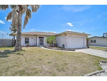 Charming single-story home with a well-maintained lawn and attached two-car garage, inviting curb appeal at 1789 Elm Dr, Venice, FL 34293