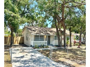 Charming single-story home with a front porch, inviting curb appeal, and beautiful trees at 2721 7Th W St, Bradenton, FL 34205