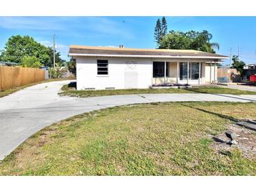 View of single-story home, with a large driveway and front lawn needing landscaping at 4221 26Th W St, Bradenton, FL 34205