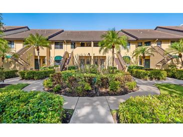 Beautiful condo exterior featuring lush landscaping and manicured bushes, creating an inviting curb appeal at 5736 Ashton Lake Dr, Sarasota, FL 34231