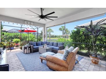 Inviting screened-in patio with comfortable seating and beautiful views of lush landscaping and waterfront at 12291 Myrtle Bay Ct, Sarasota, FL 34238