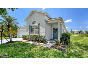 Charming single-Gathering home featuring a blue front door, well-maintained lawn, and manicured shrubbery at 12339 Hollybush Ter, Lakewood Ranch, FL 34202