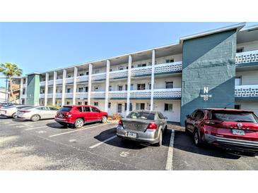 Three-story condominium building featuring parking and balconies for each unit at 1819 Restful Dr # N25, Bradenton, FL 34207