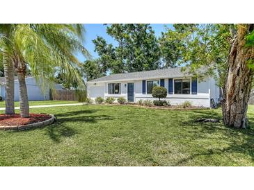 Charming single story home featuring a lush green lawn and a well maintained landscape at 2959 N Lockwood Meadows Blvd, Sarasota, FL 34234