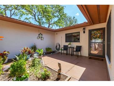 Charming courtyard with garden, table, chairs, and decorative turtle art creating a tranquil outdoor living space at 6304 Pelican Dr, Bradenton, FL 34210