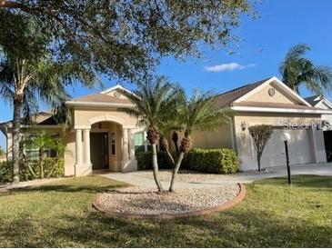 Charming single-story home with manicured lawn, palm trees, and inviting curb appeal in a sunny locale at 6415 67Th E St, Bradenton, FL 34203