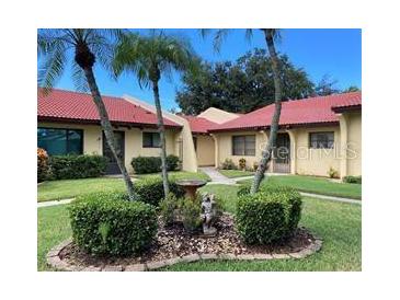 Charming villa with well-maintained landscaping, mature palms, and red tiled roof at 1414 58Th W St # 1414, Bradenton, FL 34209