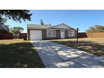 Charming exterior of home with attached garage and well-maintained yard at 2231 Lockwood Meadows Way, Sarasota, FL 34234