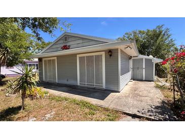 Cozy home featuring light gray siding, complemented by the lush greenery of the surrounding yard at 2448 45Th S St, St Petersburg, FL 33711