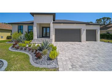 Beautiful single-story home with gray brick driveway and modern landscaping at 260 Marker Rd, Rotonda West, FL 33947