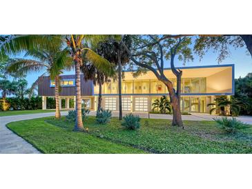 Stunning modern home with lush landscaping, ample parking and striking architectural details at 4123 Bay Shore Rd, Sarasota, FL 34234