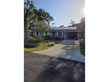 Charming single-story home with a well-maintained lawn and a welcoming covered entrance at 4700 Neptune Rd, Venice, FL 34293