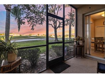 Screened patio offers serene views of the golf course and landscaping at sunset at 803 Fairwaycove Ln # 102, Bradenton, FL 34212