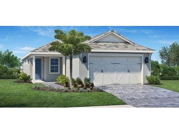 Charming single-story home with a two-car garage, a well-manicured lawn, and beautiful landscaping at 9165 Florida Rock Trl, Sarasota, FL 34240