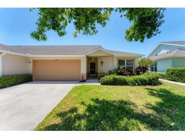Charming single-story home with a well-manicured lawn and attached two-car garage, exuding curb appeal at 3007 Live Oak Ln, Palmetto, FL 34221